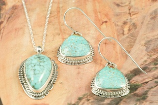 Genuine Number 8 Mine Turquoise Stones set in Sterling Silver. Beautiful Pendant and Earrings Set with an 18" Sterling Silver Chain. Created by Navajo Artists Lucy Valencia and Larson Lee. Signed. The Number 8 mine is located in Eureka County Nevada. Since 1976 there has been no Number 8 Turquoise mined. There is however, an existing stock pile that Mr. Dowell Ward, the last owner of the Number 8 mine, had stocked away for later sorting. The Turquoise is a collector's item--because once the reserve is gone there will be no more material released onto the market. The Gold Mining Company owns the claim to the Number 8 mine and it has been swallowed up by the gold mining operations. This is some of the last Number 8 Turquoise to be had and will be a great addition to your collection